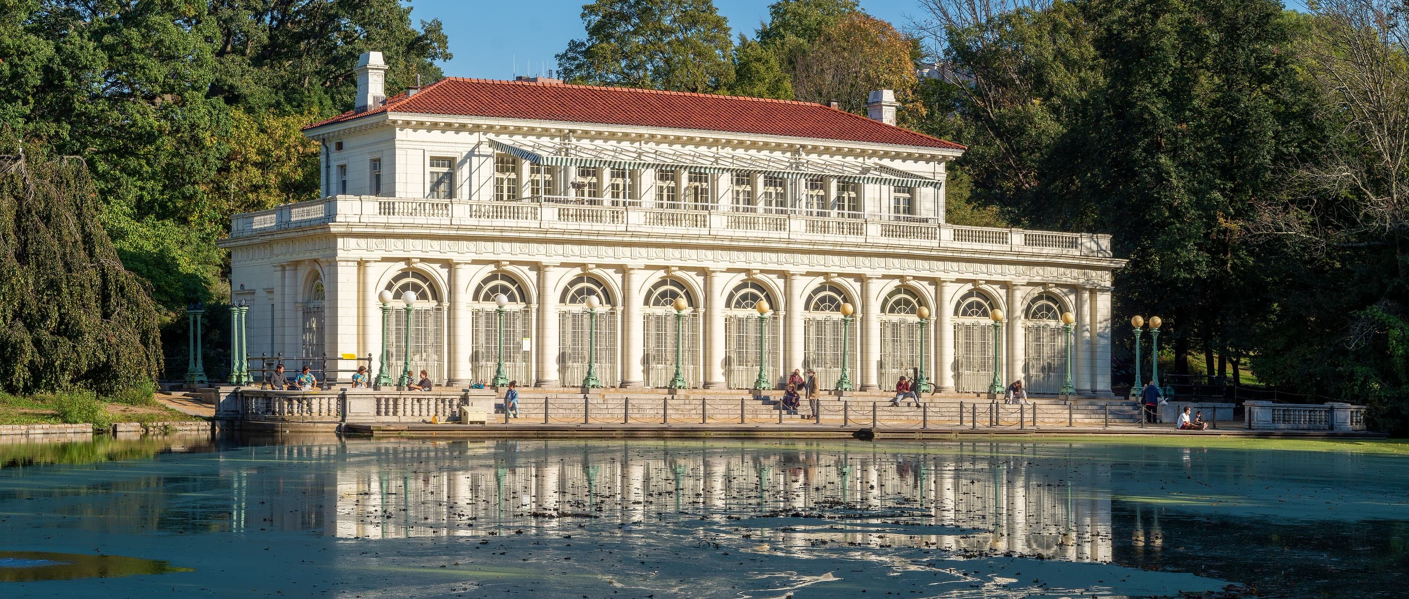 The Prospect Park Boathouse reflected in the Lullwater on an autumn afternoon